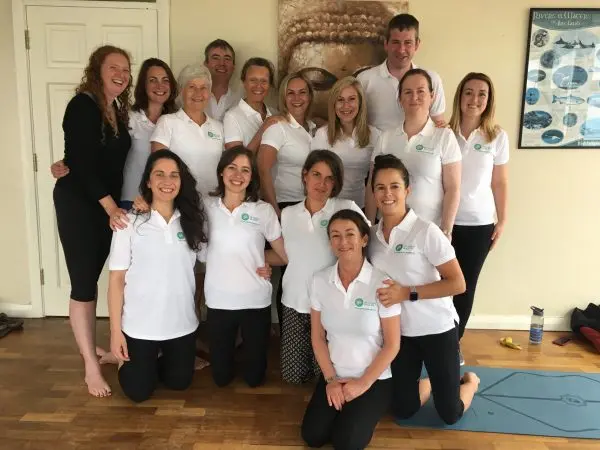 Group photo of June 2018 graduates, smiling with the course leader.